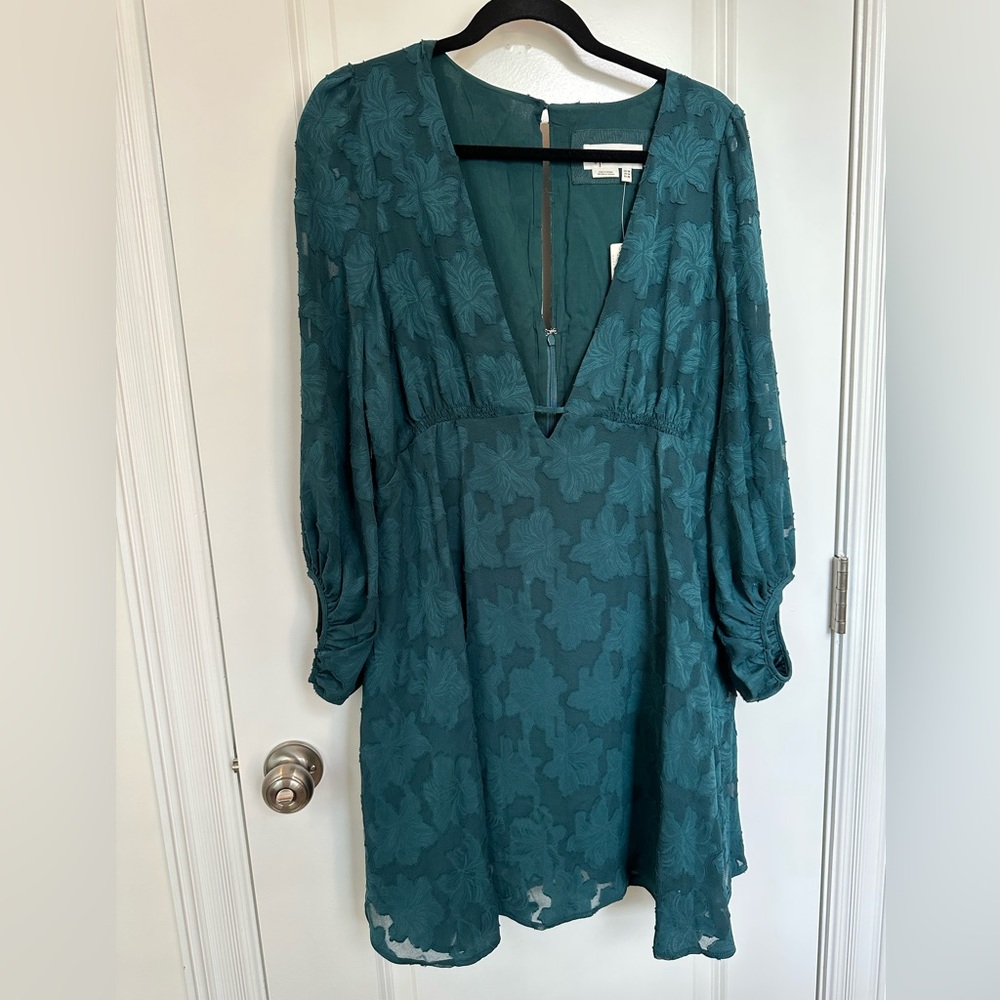 Teal green plunge dress. Very low cut with empire waist. Never worn.